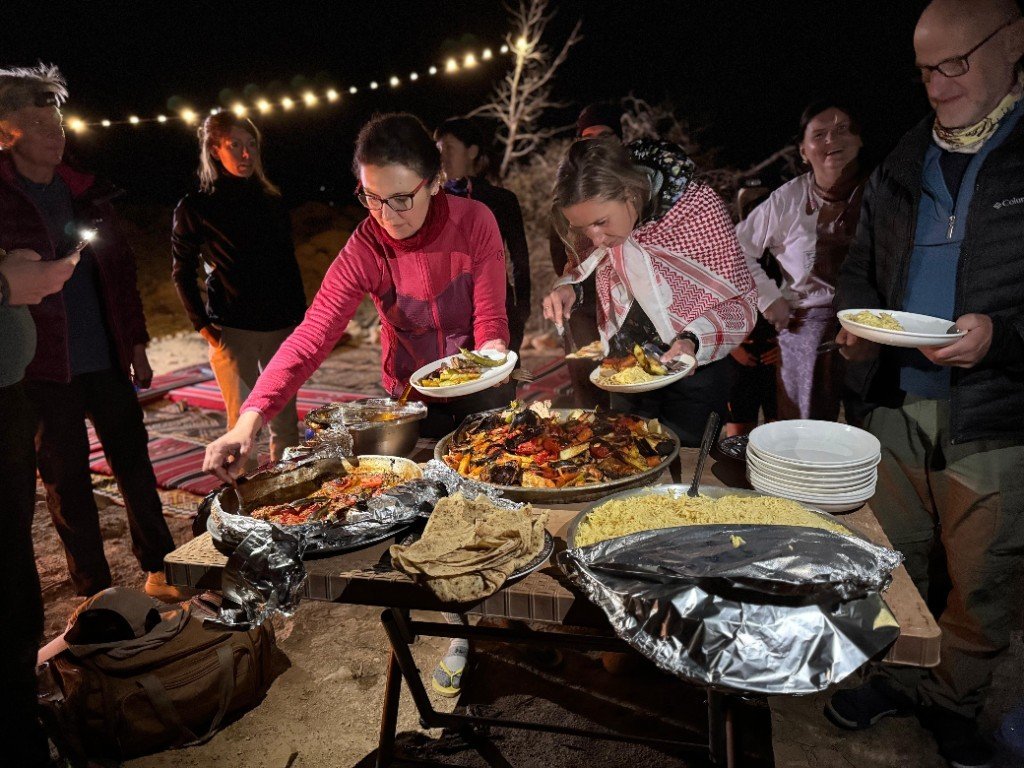 Guests sharing a freshly prepared dinner at camp
