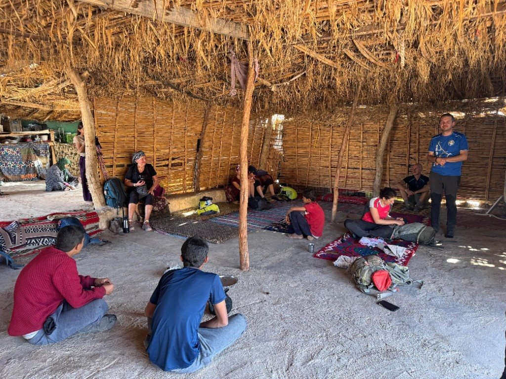 Travellers resting near Little Petra rock formations