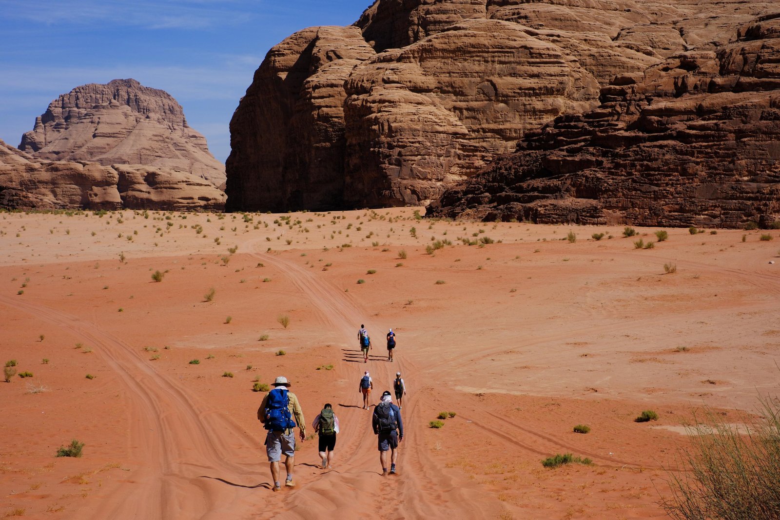Hikers walking an open stretch of the Jordan Trail